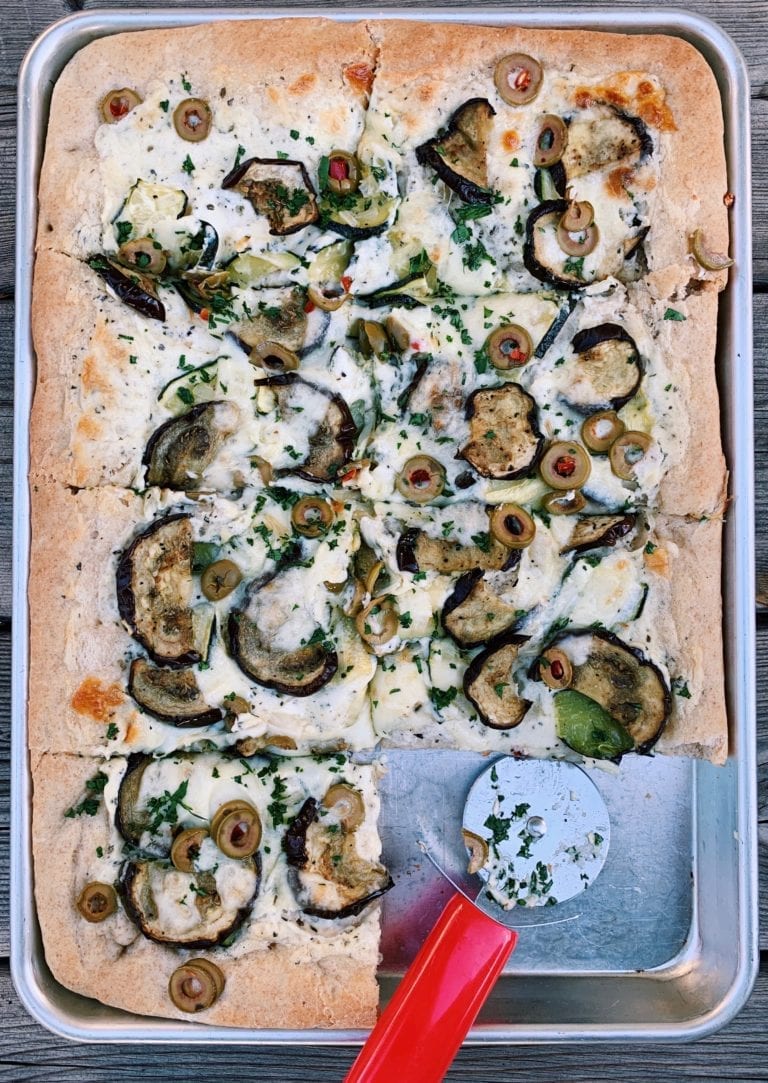 pizza in a sheet pan with eggplant, zucchini and provolone cheese.