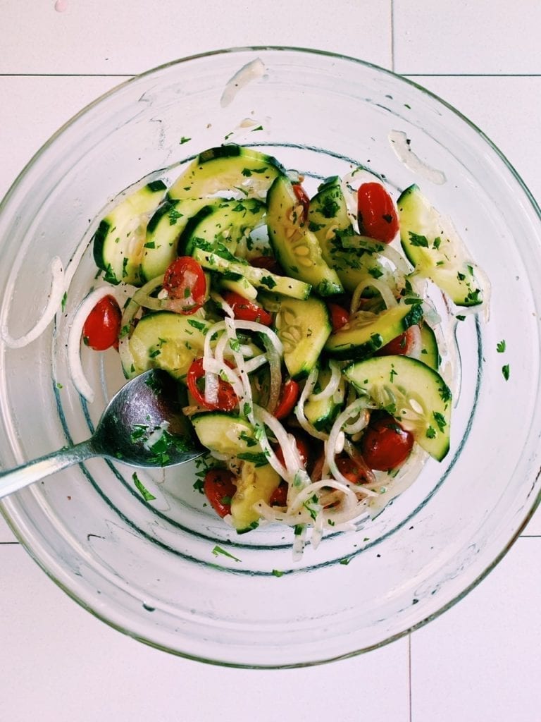 Cucumber tomato salad in a clear bowl