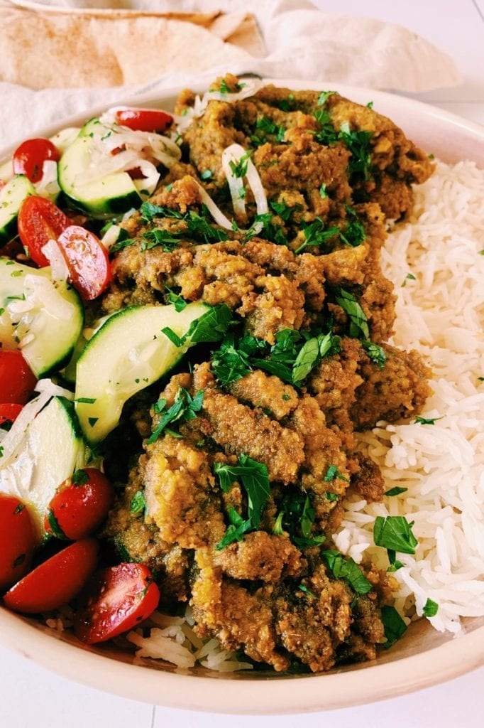45 degree angle view of lazy falafel with rice and cucumber tomato salad