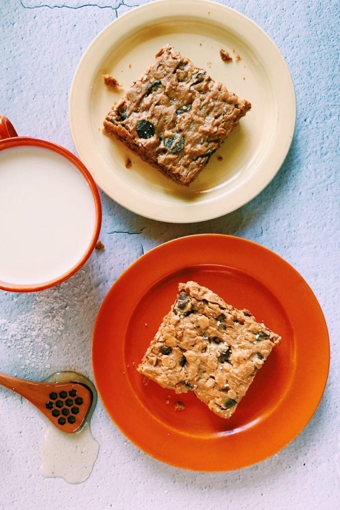 overhead shot of peanut butter and honey oar bars with a cup of milk