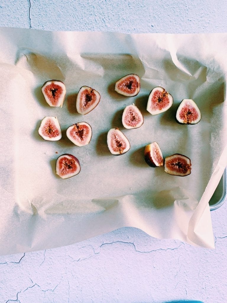 Halved figs on a baking sheet lined with parchment