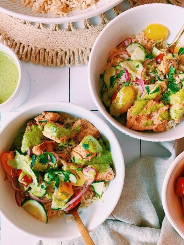 Flat lay of Mediterranean rice and chicken bowls with spicy green sauce