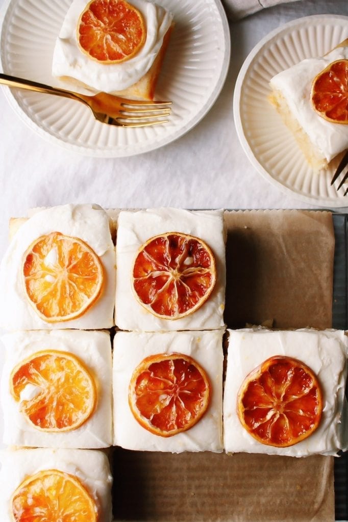 Sliced lemon cake on white plates on a white tablecloth 