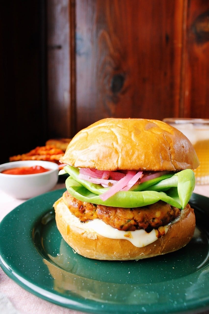 Straight-on view of apricot & curry turkey burger on a brioche bun