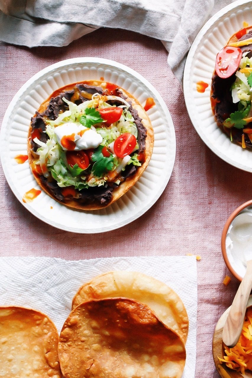 Overhead shot of homemade tostadas with refried black beans