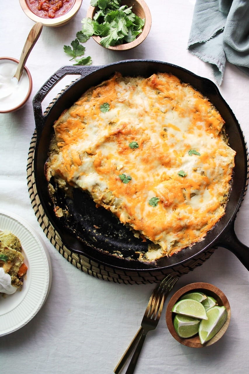 Overhead view of sweet potato black bean enchiladas with tomatillo sauce