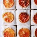 Overhead shot of lemon cake with cream cheese frosting topped with candied lemons