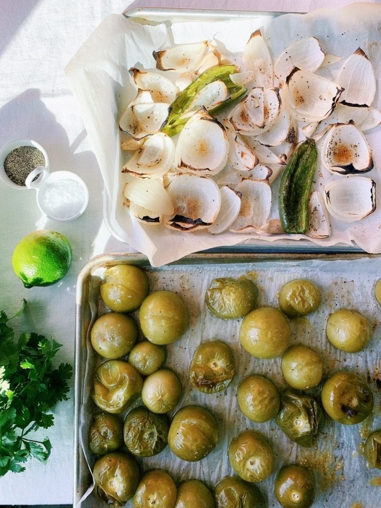 Roasted onions, jalapeno, tomatillos and garlic on baking sheets