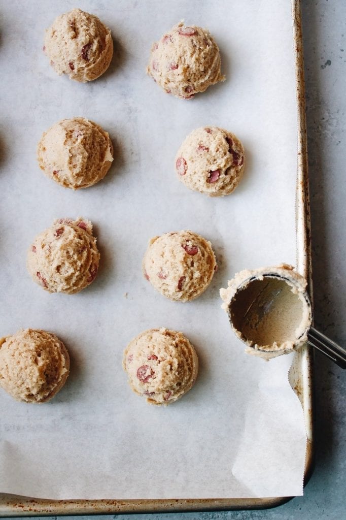 Cookie dough scooped into even balls on cookie sheet