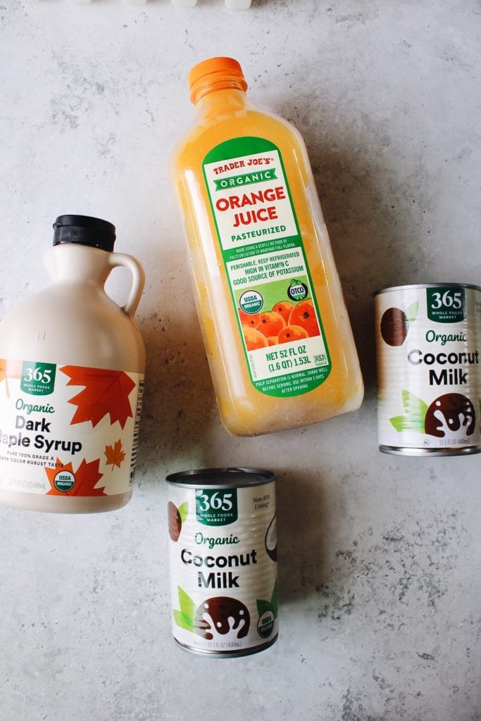 ingredients for orange coconut milk popsicles: orange juice, maple syrup and coconut milk