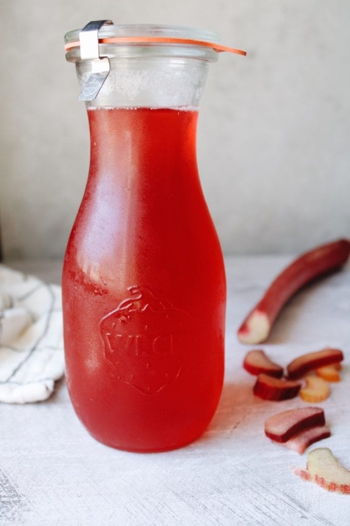 Rhubarb simple syrup in a glass bottle