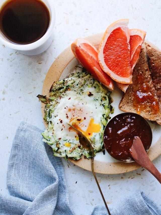 zucchini egg nest on a breakfast plate with toast and grapefuit