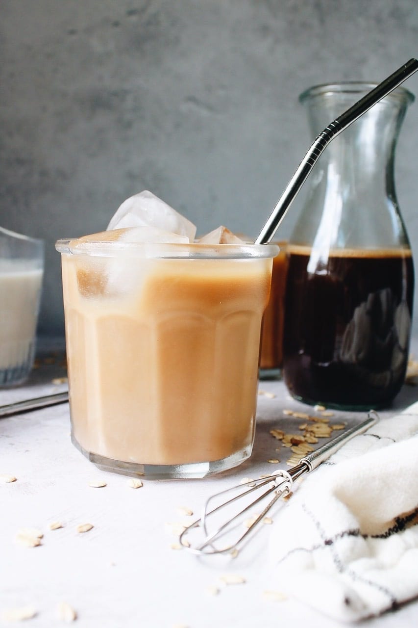 Oat milk latte in a clear glass