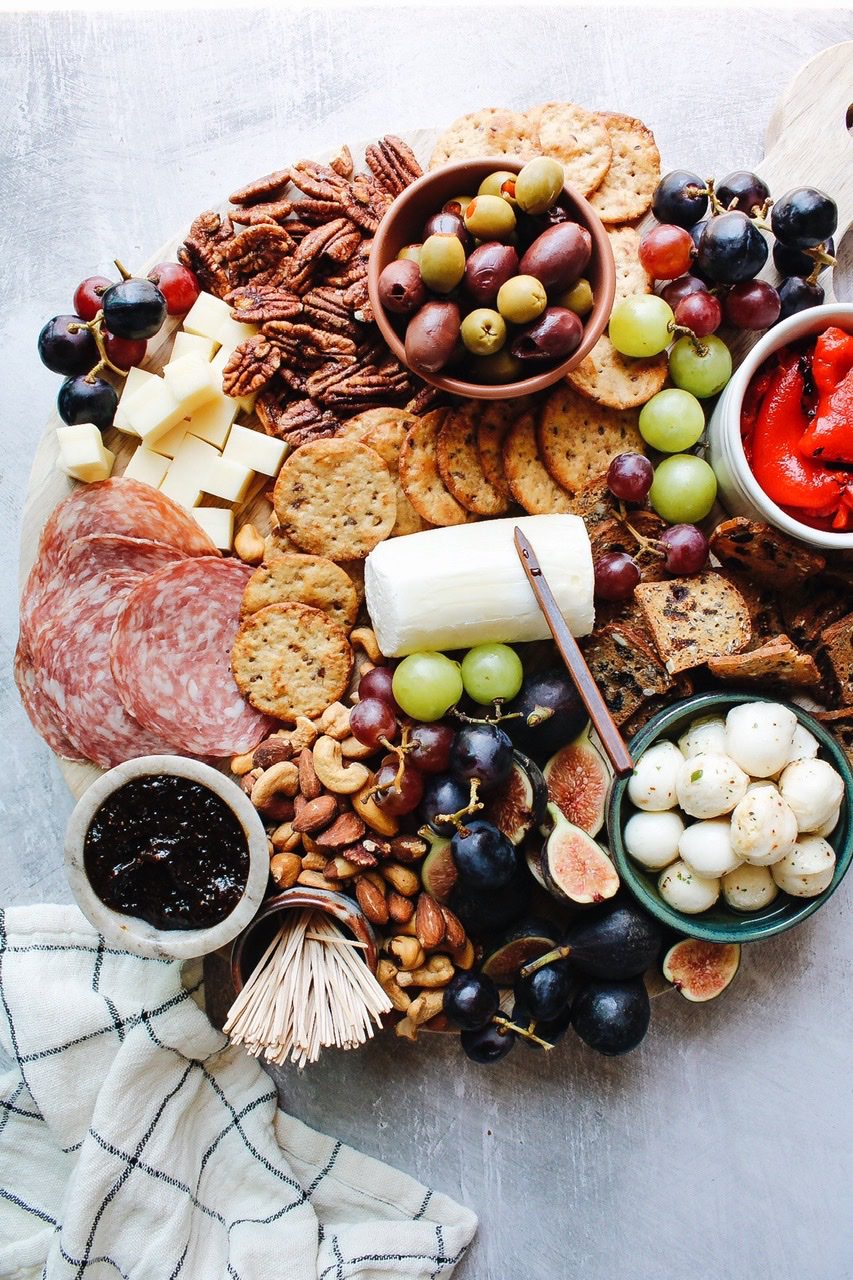 trader joes charcuterie board with meat, cheese, fruit and crackers