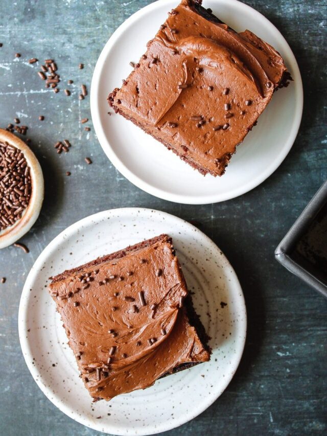 two slices of sourdough discard chocolate cake on white plates