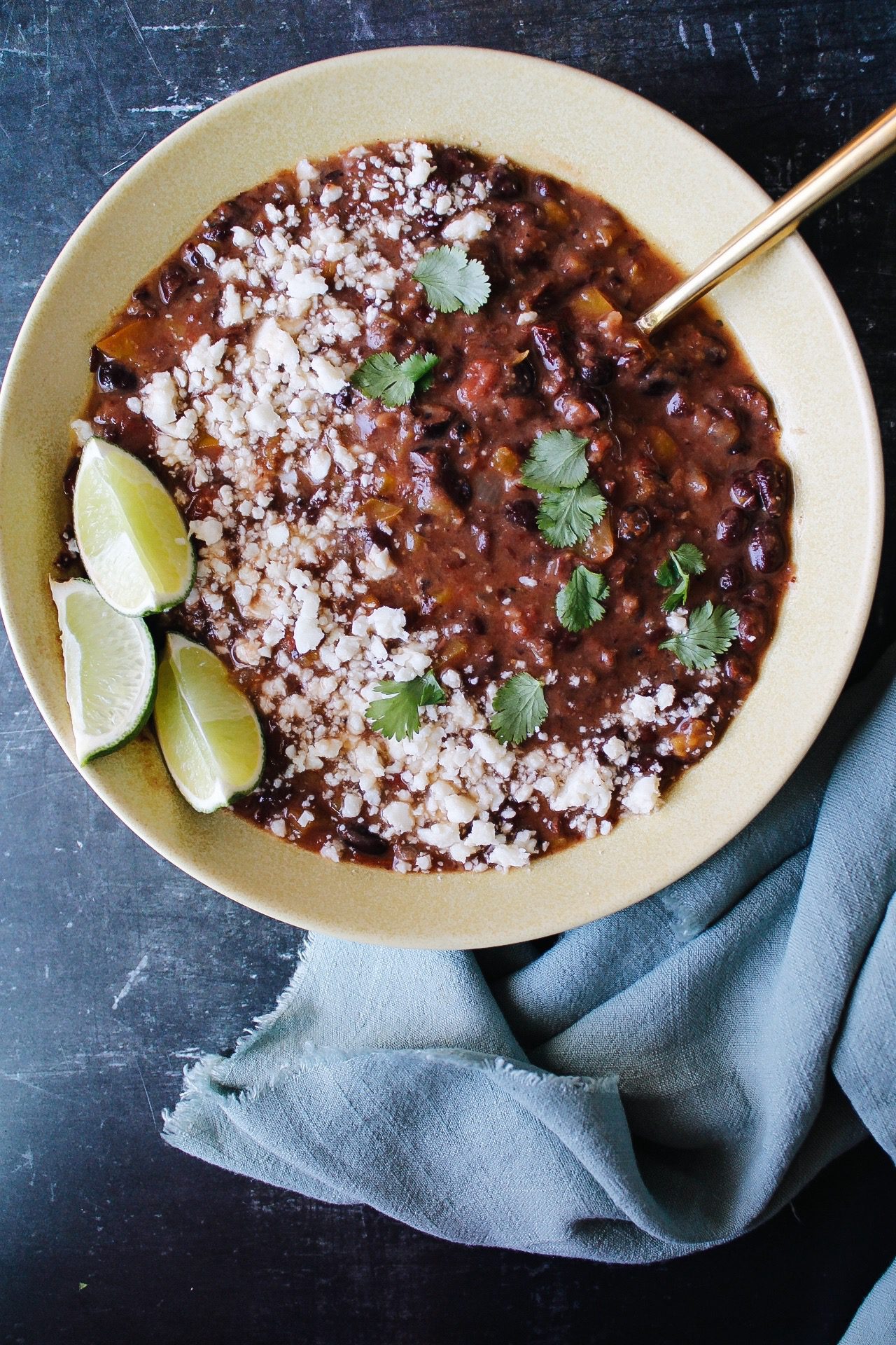 spicy black bean soup in a yellow bowl