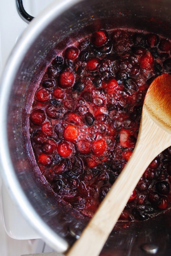 cranberry sauce cooking, cranberries are bursting 