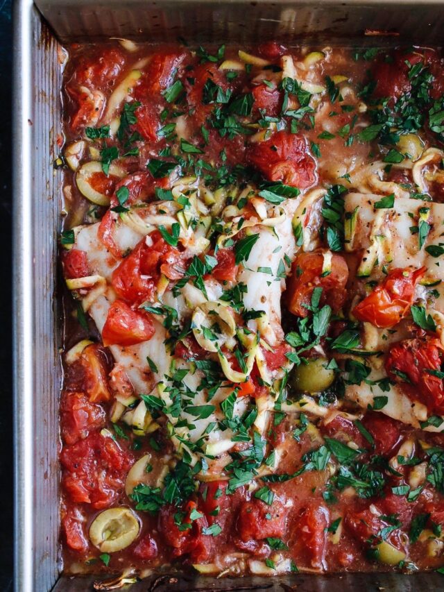 italian baked white fish with tomatoes in baking dish