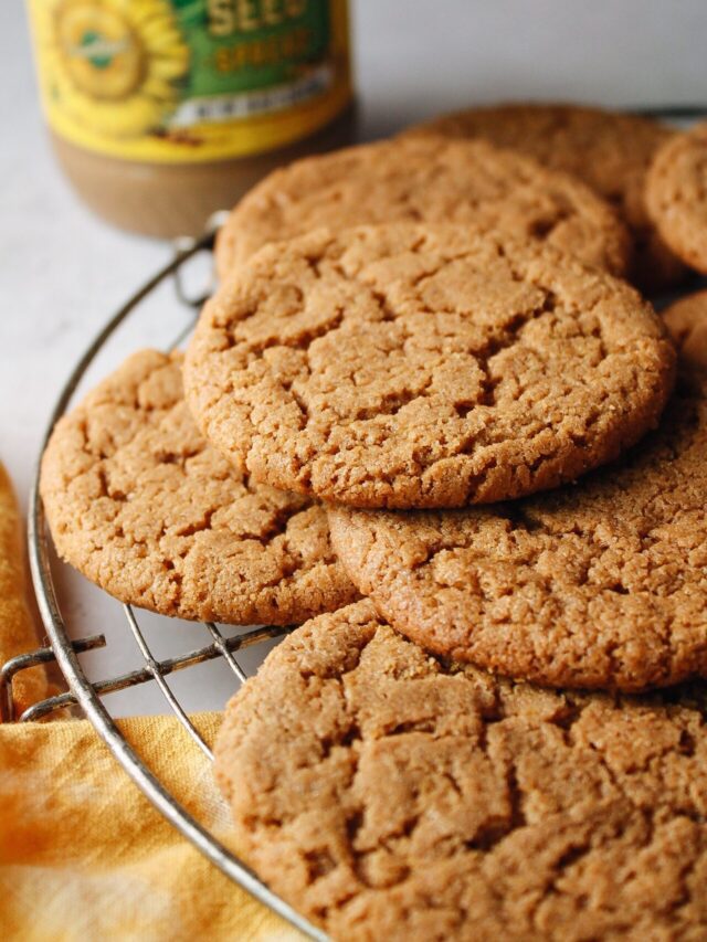 sun butter cookies with a jar of sun flower seed butter in the background