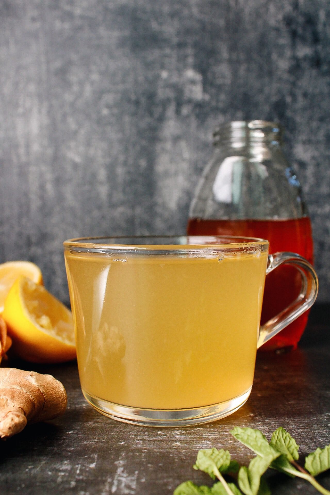 ginger mint tea in a clear glass mug