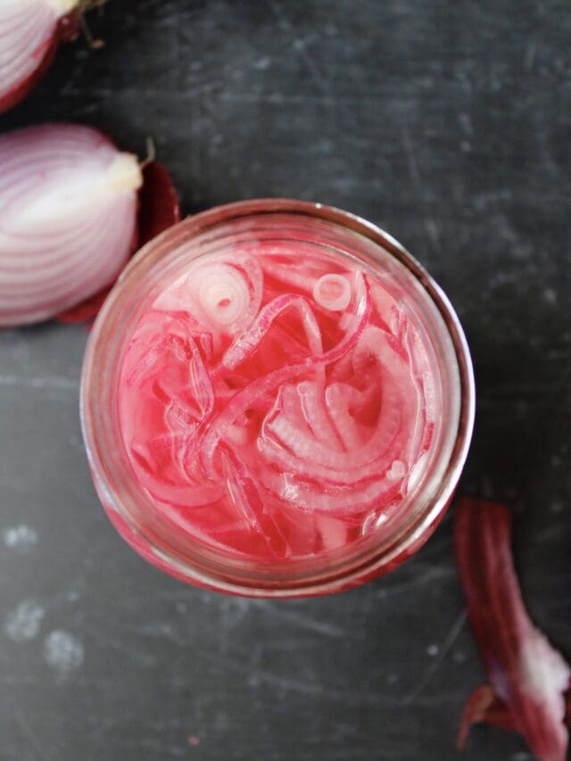 pickled red onions in a glass jar