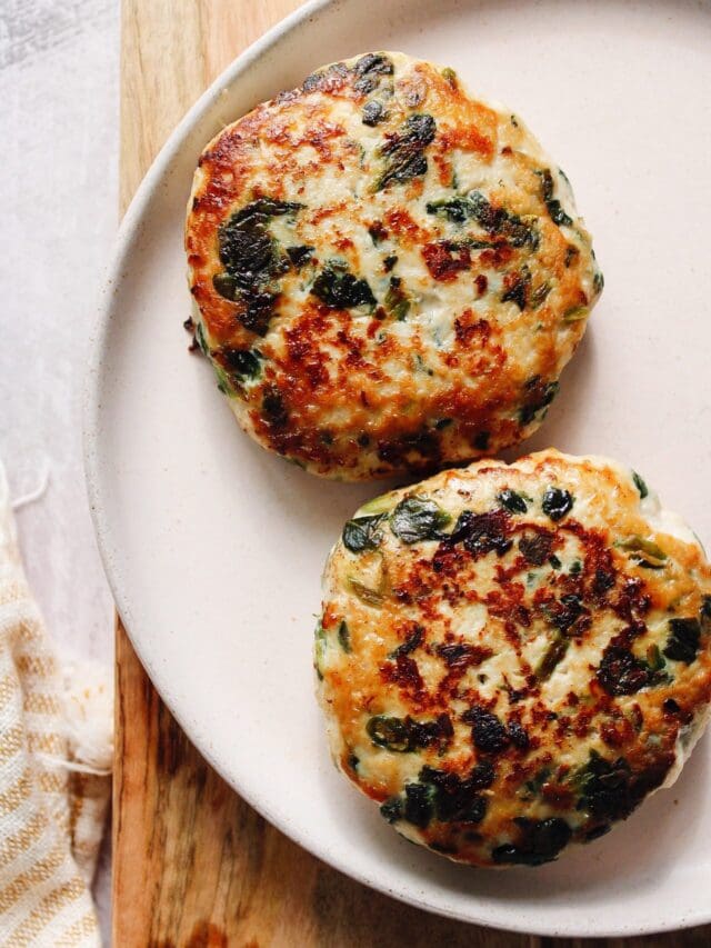 two spinach and feta turkey burger patties on a plate