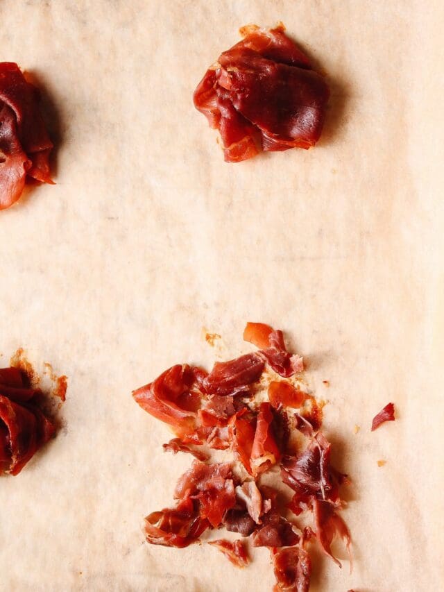 prosciutto on a parchment lined baking sheet that has been baked at 400 and crumbled into small pieces