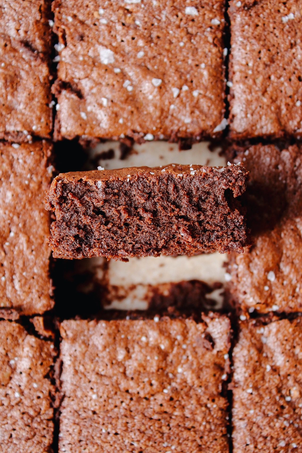 sourdough discard brownies cut and on parchment paper