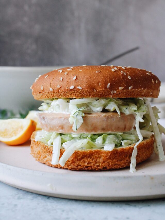 trader joes salmon burger on a bun with crunchy slaw