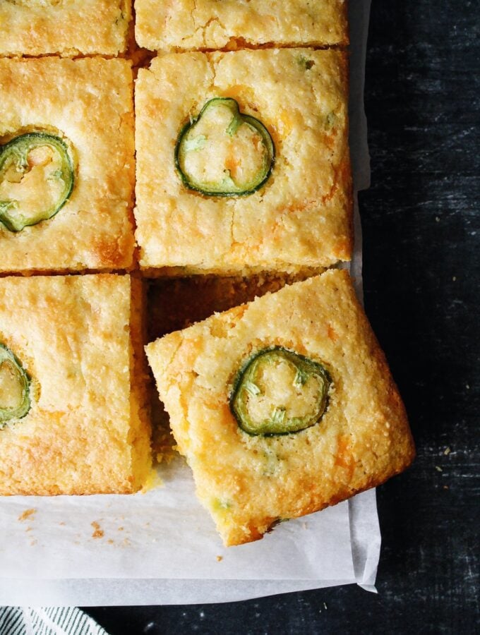 sliced of jiffy jalapeno cornbread on white parchment paper