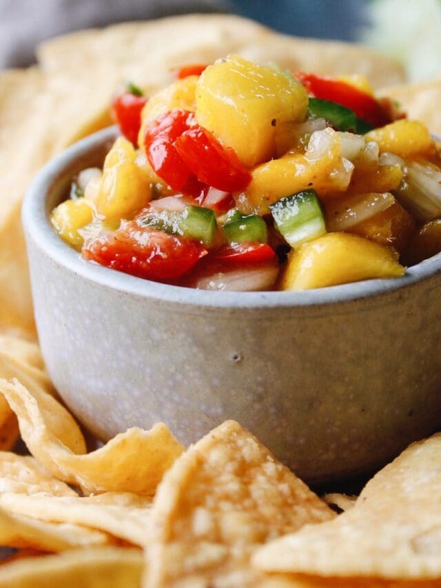 close up of mango jalapeno salsa in a blue dish