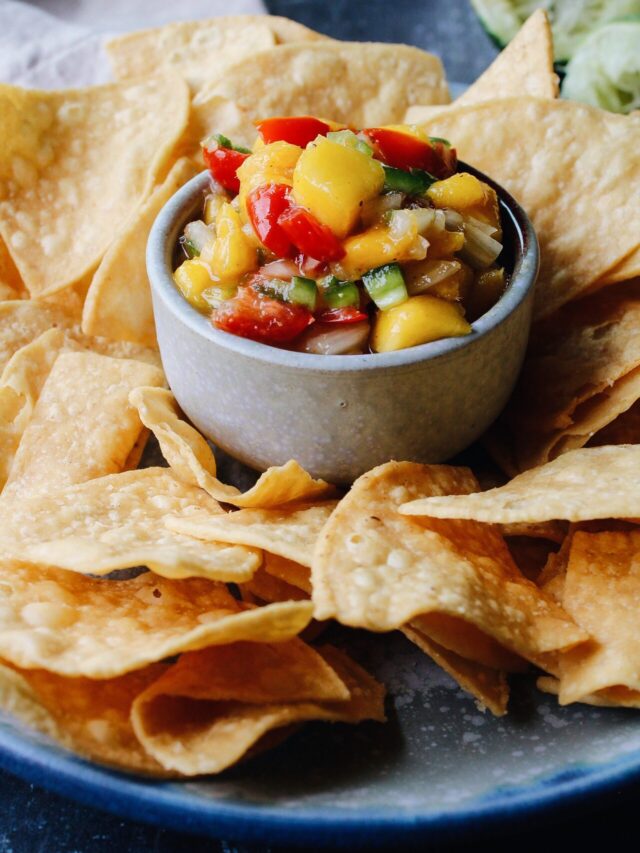 mango jalapeno salsa surrounded by chips in a chip/dip bowl