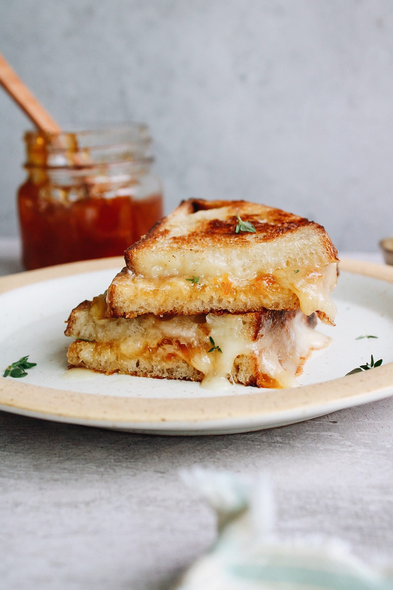 brie grilled cheese sandwich cut in half and stacked on a plate