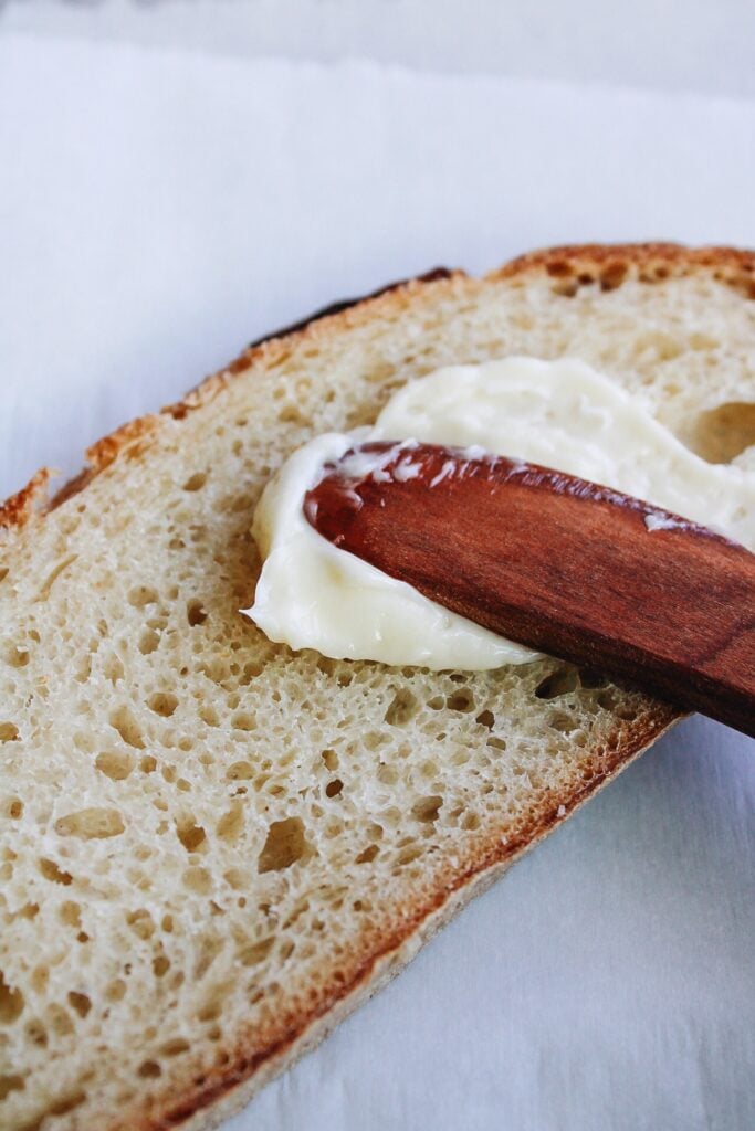 butter being spread on bread