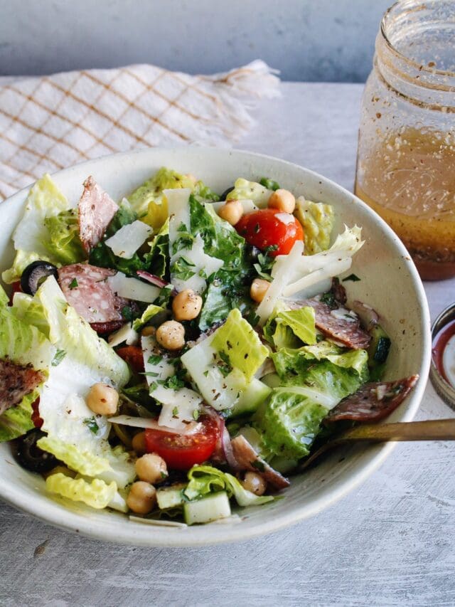 side view of italian chop salad in a white bowl