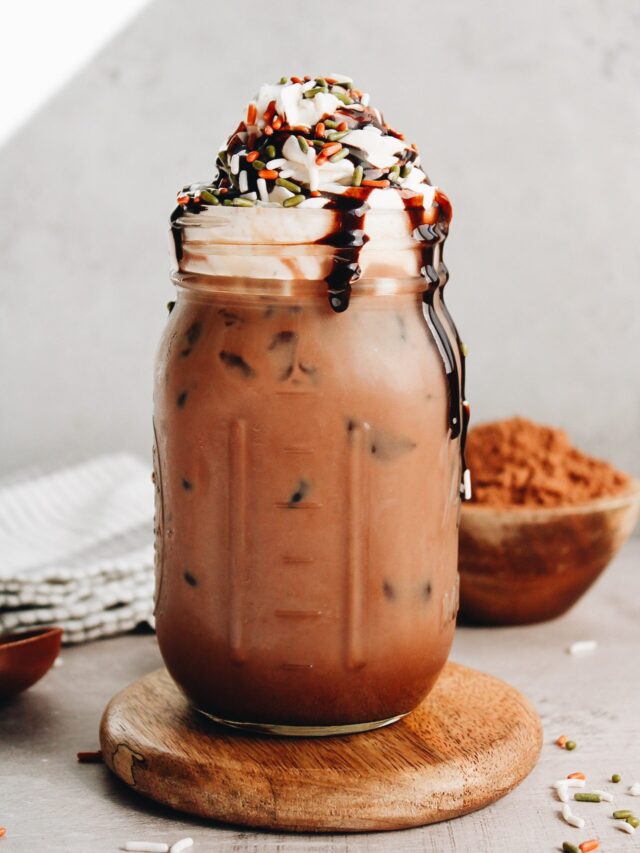 iced peppermint mocha in a jar topped with whipped cream, chocolate syrup and sprinkles