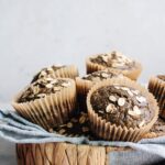 pumpkin buckwheat muffins in a basket with a blue napkin