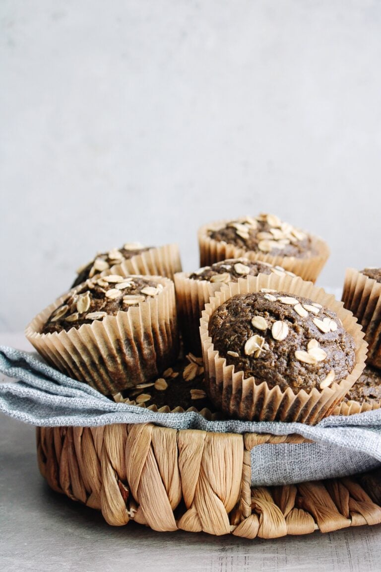 pumpkin buckwheat muffins in a basket with a blue napkin