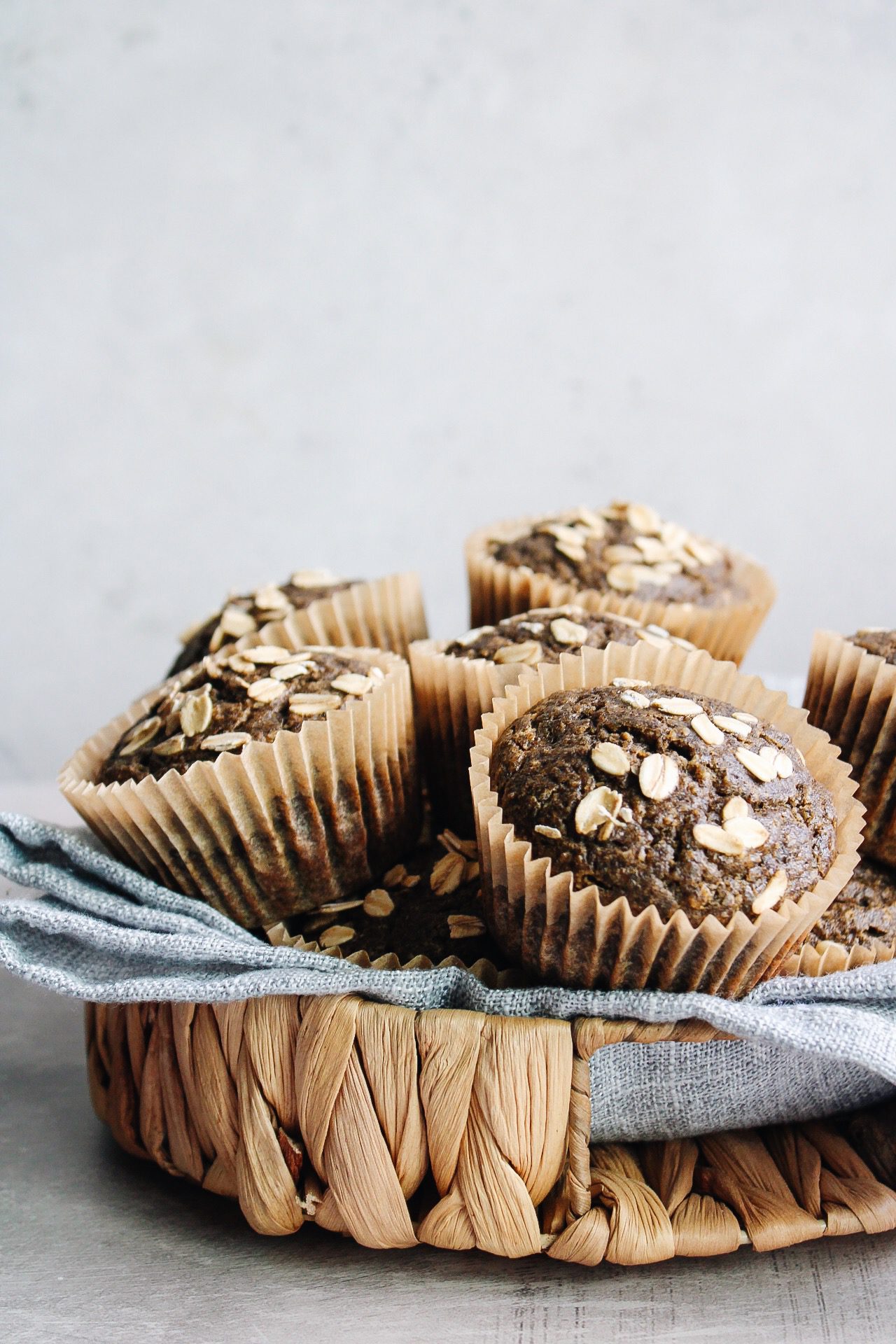 buckwheat pumpkin muffins in a basket lined with a blue napkin