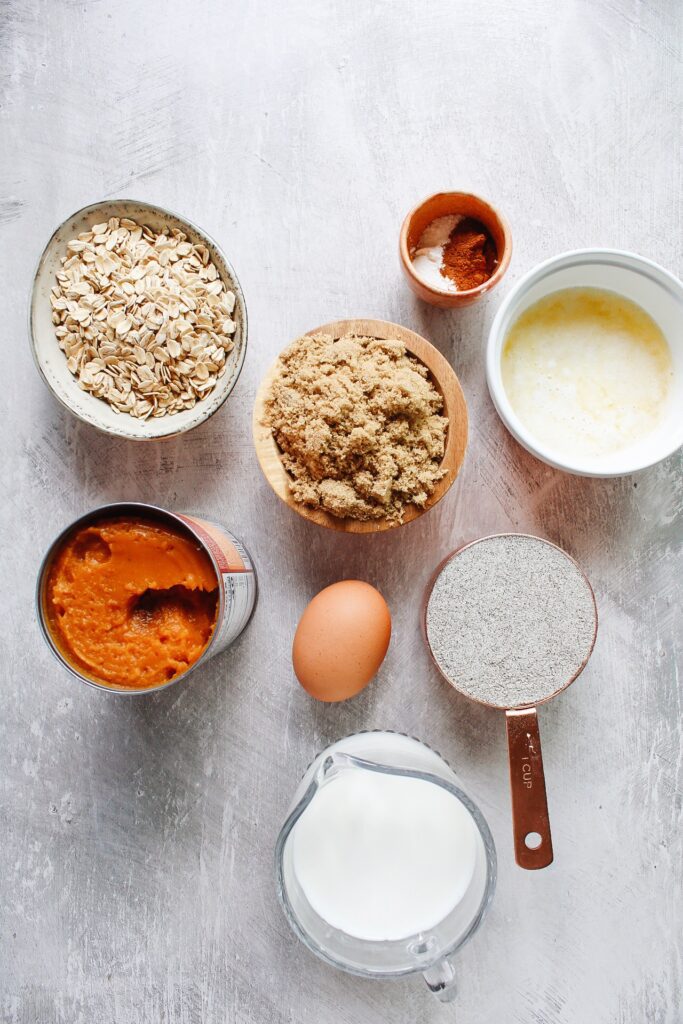 ingredients for buckwheat pumpkin muffins on a gray background