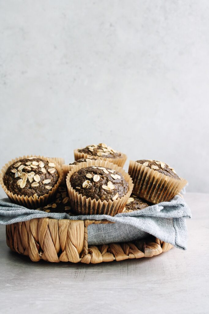 pumpkin buckwheat muffins in a basket with a blue napkin