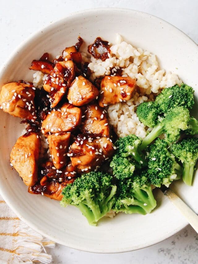 kumquat chicken in a white bowl with rice and broccoli