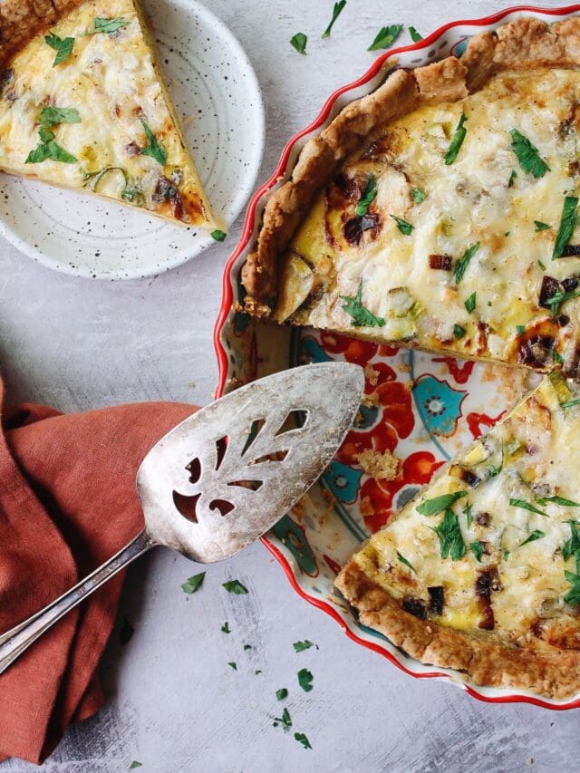 potato and leek quiche with a slice removed and on a plate