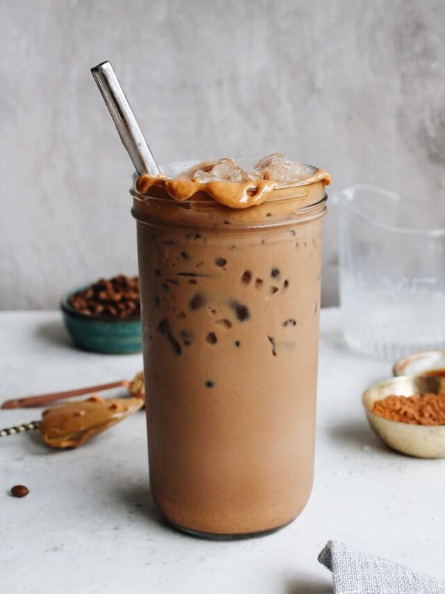 peanut butter mocha in a glass jar with peanut butter along the rim