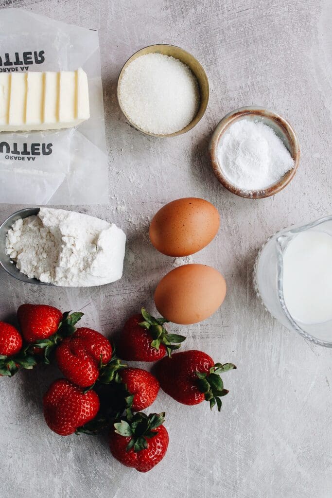 ingredients for strawberry buttermilk scones on a gray counter