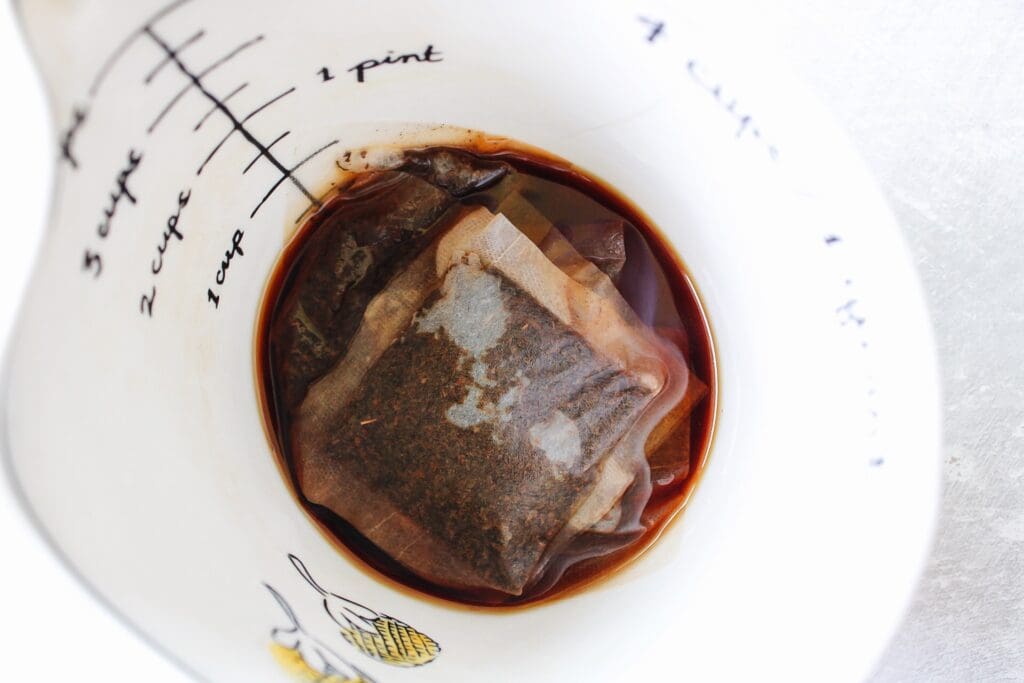 a small amount of water with black tea bags steeping in it