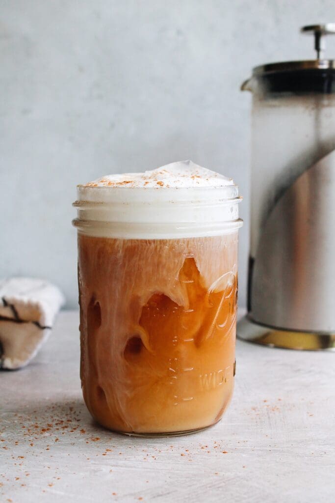 cold brew coffee made in a french press with milk foam on top