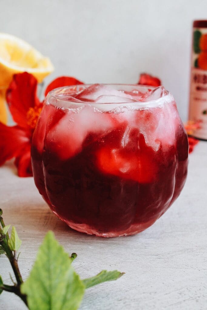 close up of hibiscus lemonade in a clear glass with ice