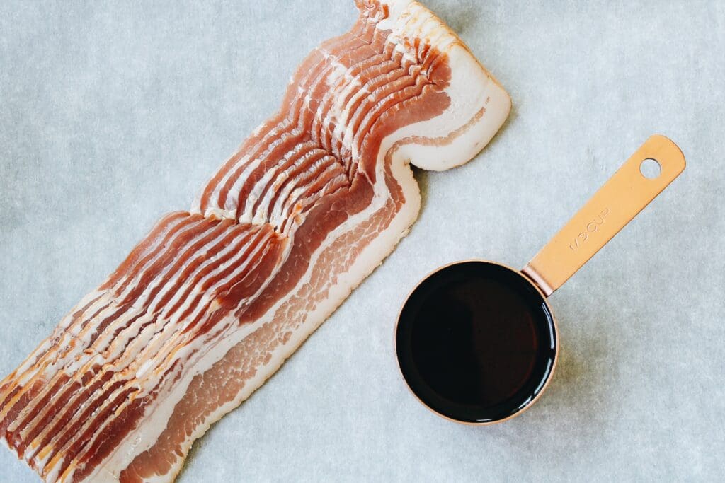 maple syrup and bacon on a piece of parchment paper