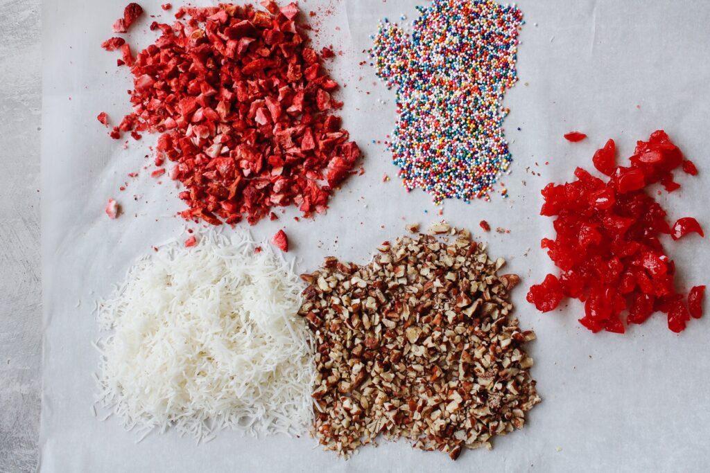 toppings for banana splits on a piece of parchment paper